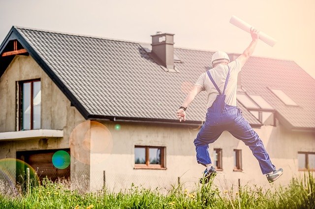 Image by Michal Jarmoluk from Pixabay, a man jumping in fron of a house