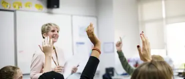 Students With Their Hands Up Responding To Their T 2023 11 27 05 00 39 Utc